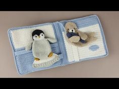 two crocheted stuffed animals sitting on top of a blue and white blanket,