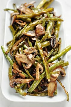 green beans with mushrooms on a white plate