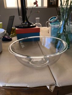 a glass bowl sitting on top of a wooden table