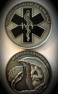 two metal medallions with medical symbols on them