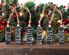 christmas decorations are arranged on top of wooden blocks with the words joy, peace, love and joy