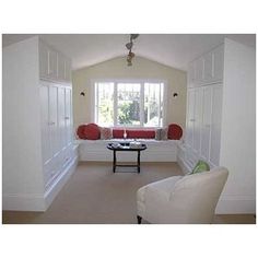 a living room filled with furniture and white walls