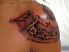 a woman's shoulder with music notes and musical notes on the top of it