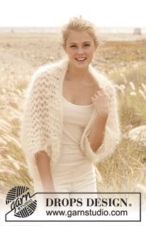 a woman standing in a field wearing a knitted cardigan