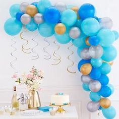 a blue and gold balloon arch for a birthday party