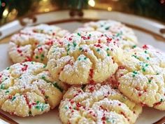 a white plate topped with cookies covered in sprinkles