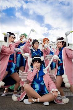 a group of women dressed in costumes posing for a photo