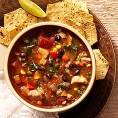 a bowl of mexican chicken soup with tortilla chips