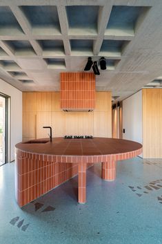 an empty kitchen with orange tiles on the ceiling and counter tops, as well as wooden cabinets