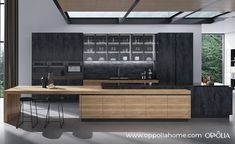 a modern kitchen with wooden cabinets and black counter tops, along with bar stools