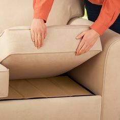 a woman is holding the back end of a couch