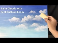 someone is painting clouds with seat cushion foam