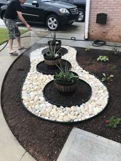 a man is using a hose to water plants