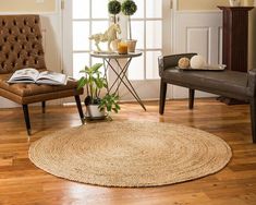 a living room filled with furniture and a rug on top of a hard wood floor