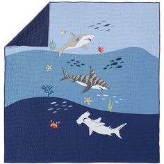 an ocean scene with sharks and other marine creatures on the blue quilted bedding