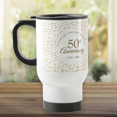 the 50th anniversary coffee mug is sitting on a table