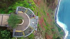 an aerial view of people walking along the coast