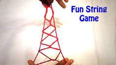 a hand holding a red string that is connected to a tower with the words fun string game on it