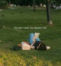 a person laying on the ground reading a book with birds in the background and text that reads, the less i care, the happier i am