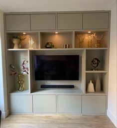 a flat screen tv sitting on top of a white entertainment center