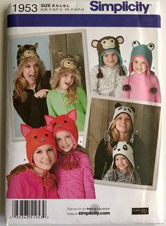 two girls wearing animal hats and one girl in a cat hat are smiling at the camera