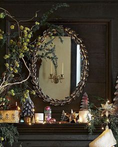 a fireplace mantle decorated with christmas decorations and candles