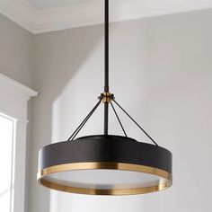 a black and gold chandelier hanging from the ceiling in a room with white walls