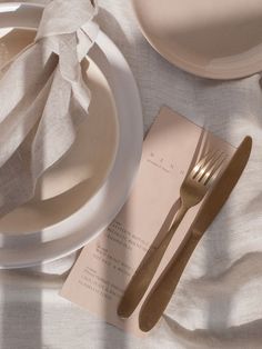 an image of a table setting with napkins and silverware on top of it