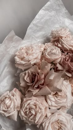 a bunch of flowers that are laying on some paper