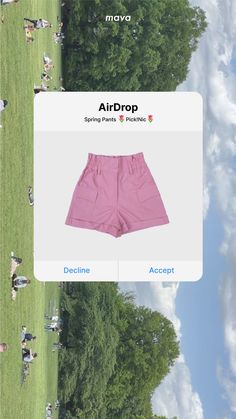 the pink shorts are on display in front of some trees and people sitting around them