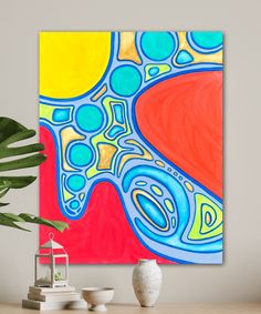 an abstract painting on a wall next to a potted plant