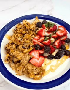 a white plate topped with fruit and granola