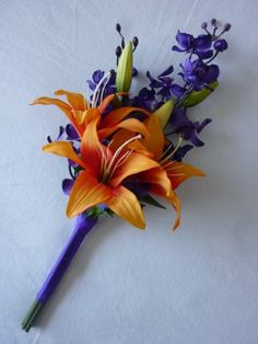 an orange and purple flower on a white surface