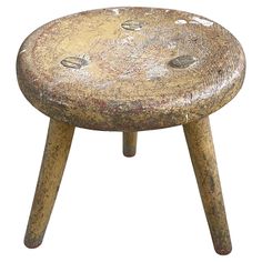 an old wooden stool with holes in the top and bottom, on a white background