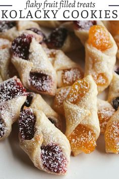 several pieces of fruit filled cookies on a white plate with text overlay that reads, may fruit filled treats kolacky cookies