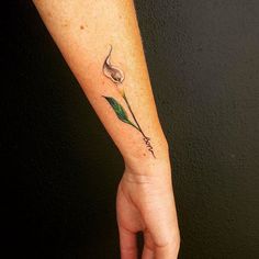 a woman's arm with a flower tattoo on it