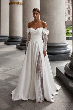 a woman in a white wedding dress posing for the camera