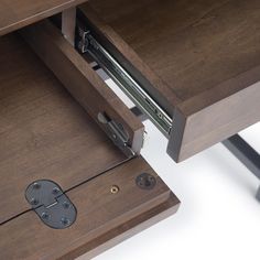 a close up of a drawer on a desk with an open file cabinet underneath it