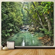 a wall hanging on the side of a wooden floor next to a river and trees