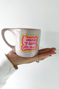 a woman's hand holding a coffee mug with the words, i learned my hair for this?