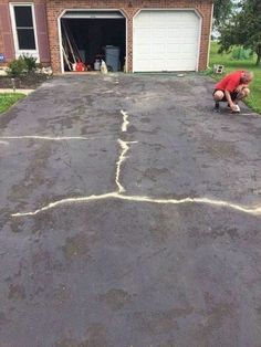 a man kneeling down in front of a garage