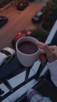 a person holding a cup of hot chocolate