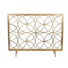 a metal and wood cabinet with circles on the front, in gold leafy design