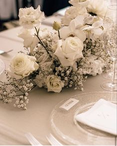 white flowers and baby's breath on a table