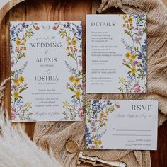 the wedding stationery is laid out on a table