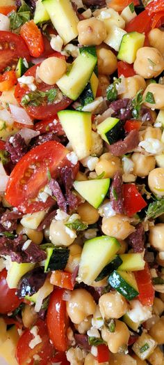 a salad with tomatoes, cucumbers, and other vegetables