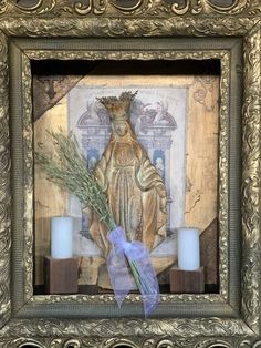 an ornate frame with candles and a statue in the middle is adorned with a blue ribbon