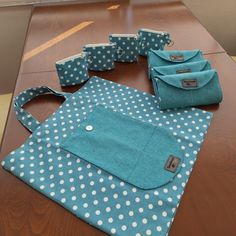 blue and white polka dot bags sitting on top of a wooden table