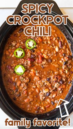 the recipe for spicy crockpot chili is shown in a black bowl with green peppers on top