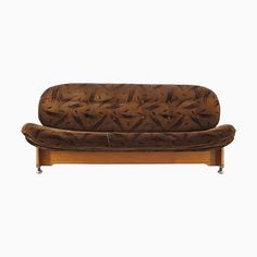 a brown couch sitting on top of a wooden frame